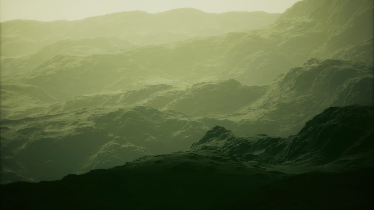 Mysterious green landscape shrouded in fog during early morning hours