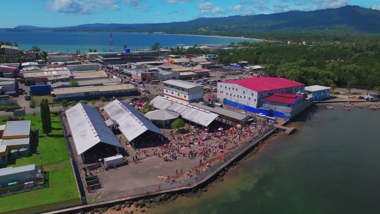 Sundaun fish Market Wewak Hill buildings people Boram road Wewak Papua New Guinea aerial drone downtown coastal town Sundaun Market Dogreto Bay Cape Wom Bismark Sea sunny blue sky morning static shot