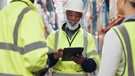 warehouse workers discuss on tablet