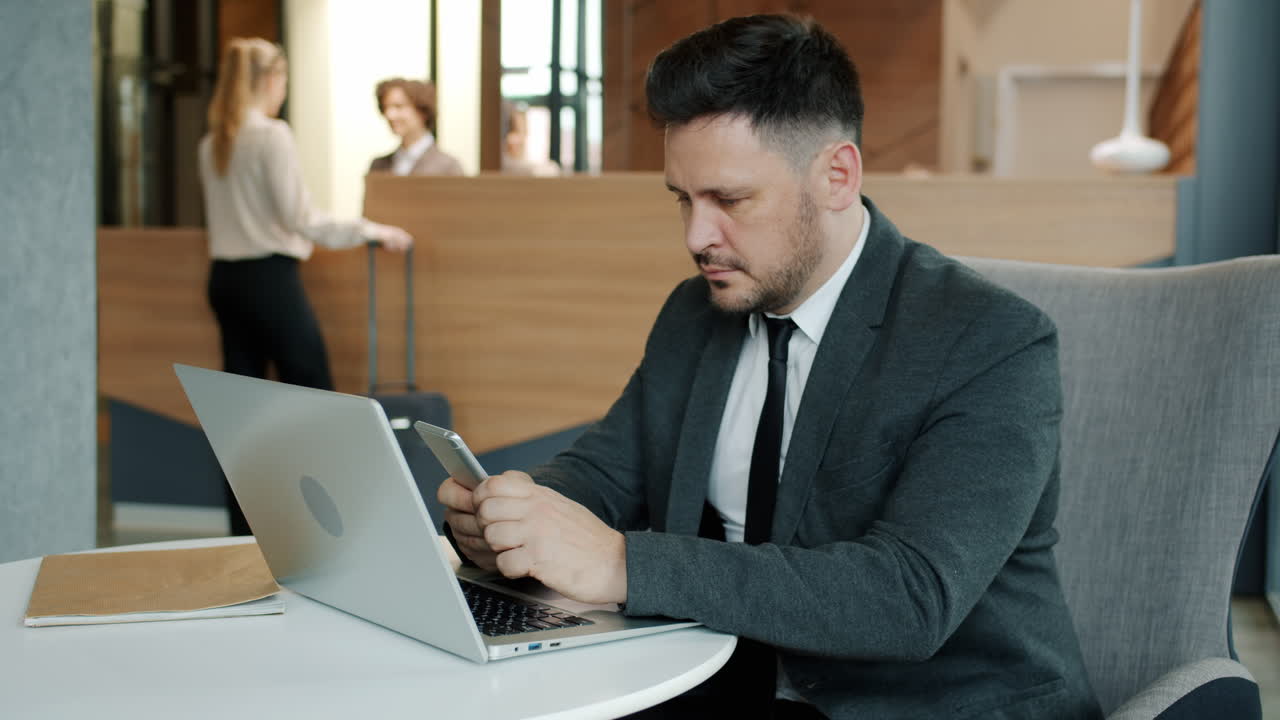 Businessman working in a hotel lobby