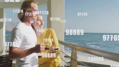 couple enjoying ocean view with floating numbers animation over scene