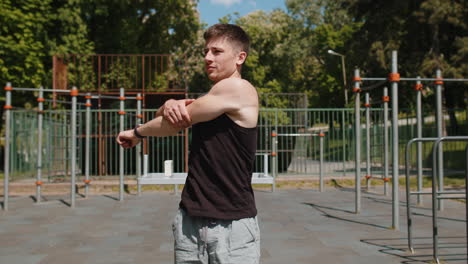 athletic caucasian man in sportswear stretching body and warm up before cardio workout exercises