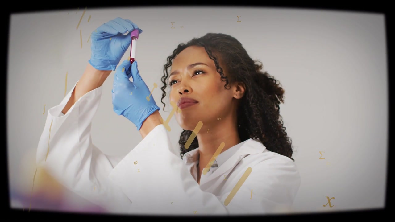 Lab technician holding blood vial near chest, raising and rotating it while checking clarity, fill