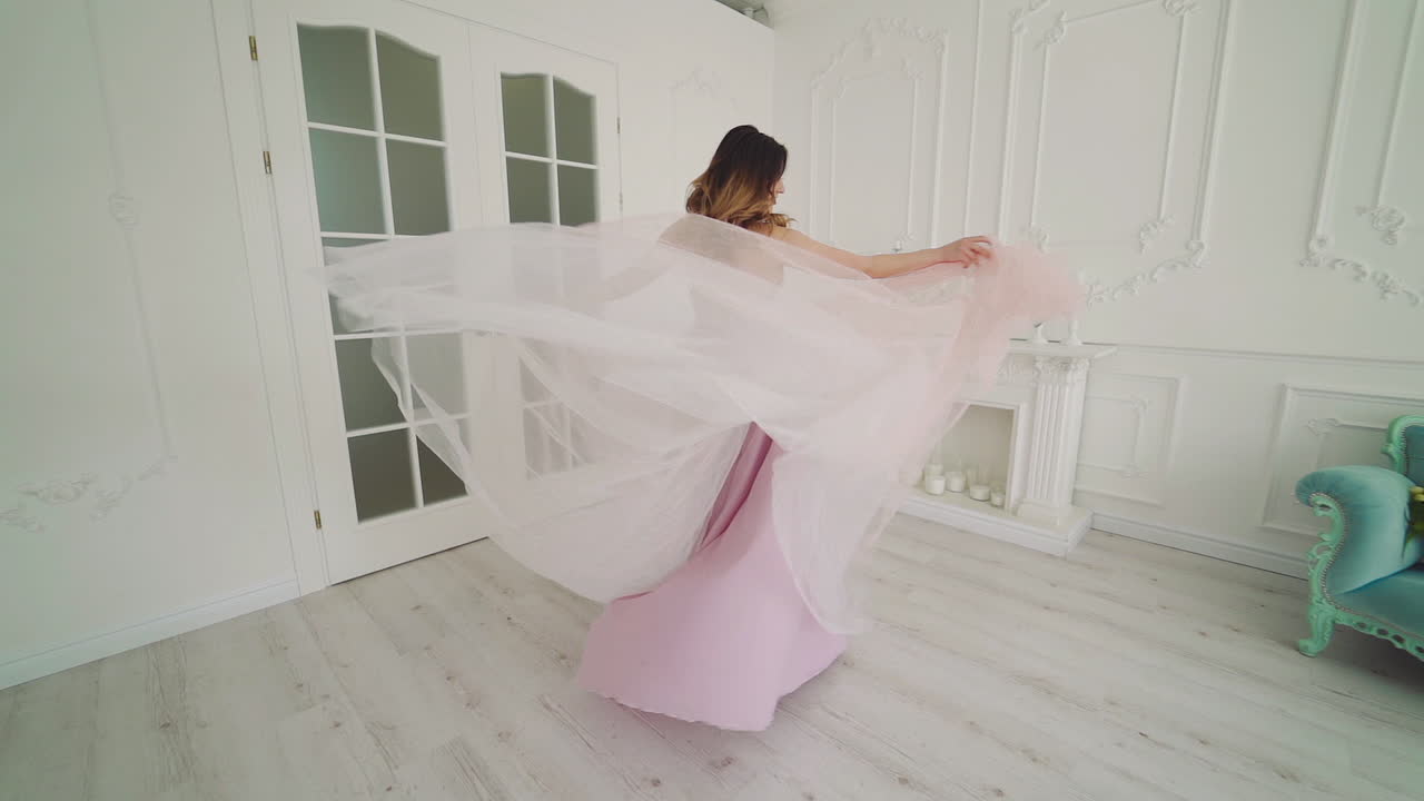 Beautiful bride in luxury hotel room. View of young happy bride in dress in room
