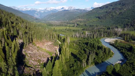 Mountain-Landscape-Aerial-Drone-Panning-Up-to-Show-Soo-River-Pine-Trees-Canada-4K