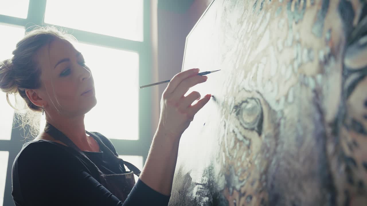 Woman painting a tiger portrait in a studio
