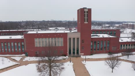 front entrance, facade of large american school, college building during winter