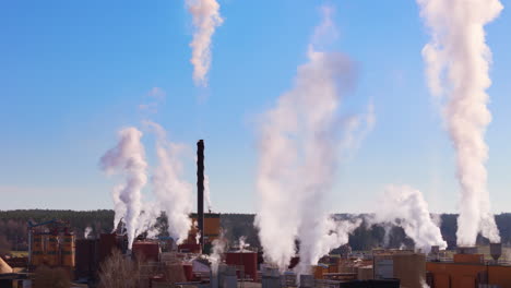 birds'-eye view of harmful greenhouse gases emitted at factory into atmosphere