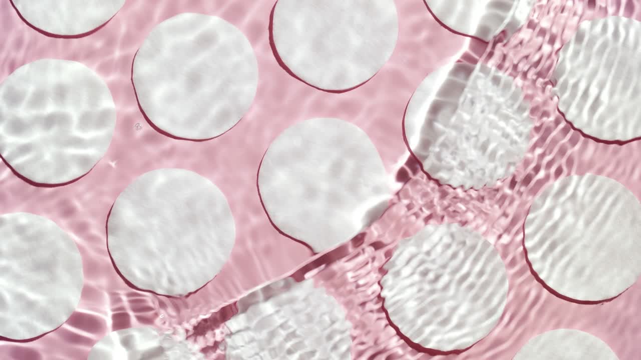 Wave creates ripples and drop falls on water creating circles