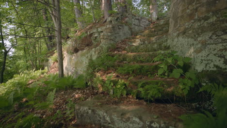 Slowly-moving-up-moss-covered-brick-stairway-in-the-forest