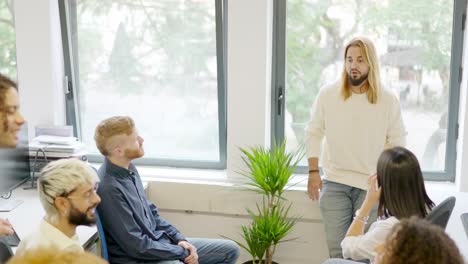 young man talking during a business meeting in a coworking