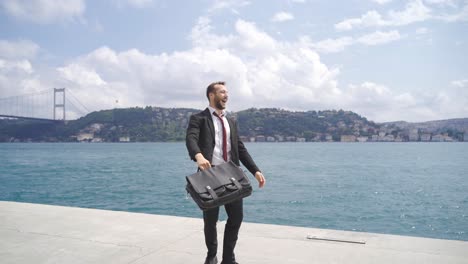 businessman reaching his goal rejoicing by the sea.