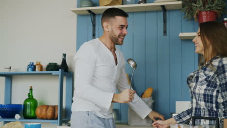 happy couple having fun in the kitchen
