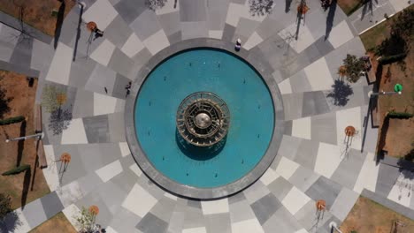 aerial view of a circular park with fountain