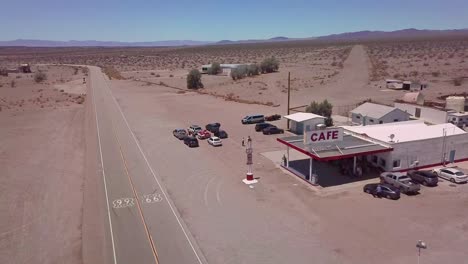 drone aerial over a lonely desert gas station and hotel motel cafe in the mojave desert 2