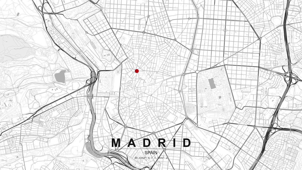 Detailed map of Madrid, Spain showing a dense street grid and road network with a red location pin marking a central urban area