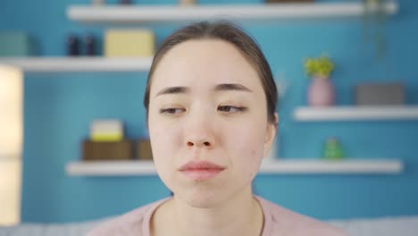 close-up portrait of frustrated asian young woman.