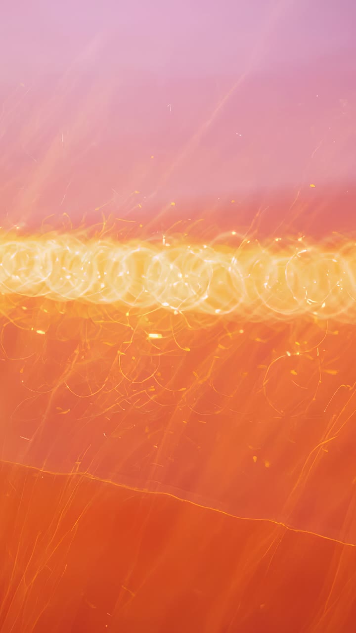 Vertical video: Playing horizontal band with circular bokeh shifting across pink gradient loop