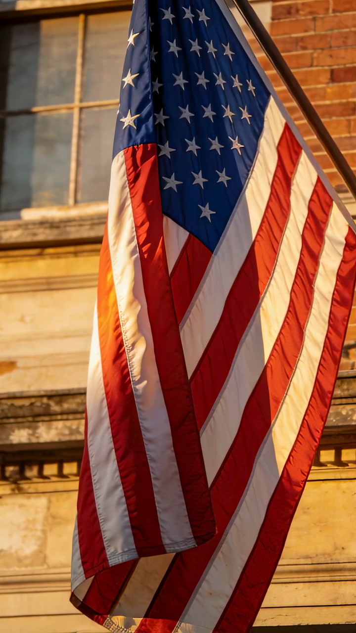 Vertical video: Fluttering United States flag moving in light breeze at facade, showing flagpole