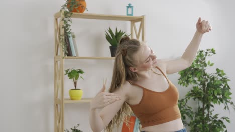 young woman dancing/meditating at home