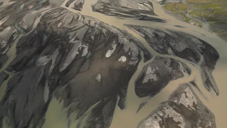 icelandic glacier stream flowing through the canals under crepuscular rays