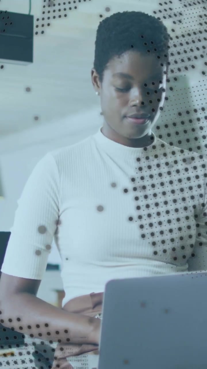 Vertical video: Woman glancing at laptop and typing for office work, dotted film fragmenting form