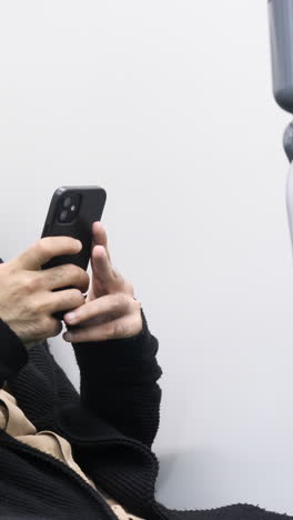 person using smartphone on public transport