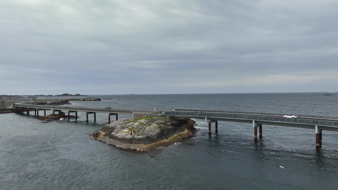 мирберхольмский мост с атлантическим океаном на заднем плане вдоль всемирно известной атлантической океанской дороги в норвегии - панорамный аэрофотоснимк моста при плавном движении вперед и влево