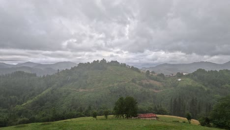 drifting grey clouds drop heavy rain onto green agriculture hillsides