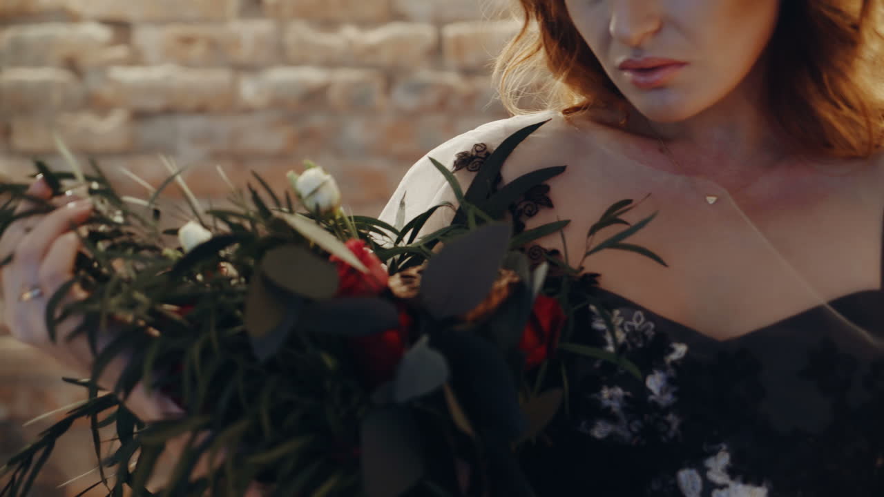 Witch sitting by the table. Portrait of young witch woman sitting at table in room