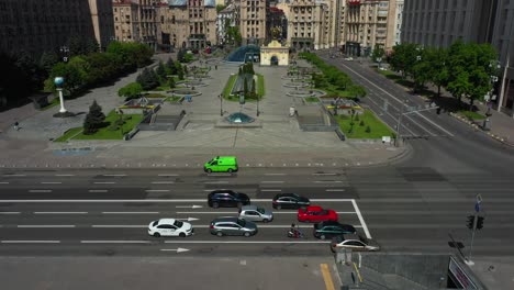 aerial view of a city square with cars and pedestrians