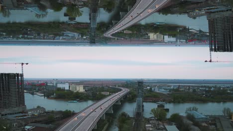 vista aérea de un puente sobre un río con reflejos y paisaje urbano