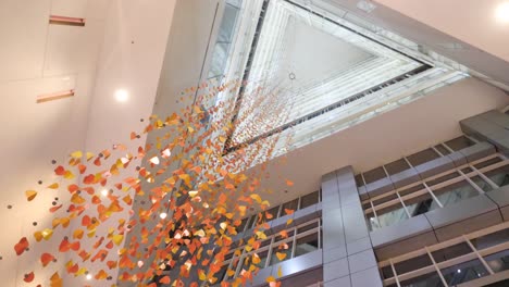 modern lobby with orange leaf-shaped hanging decor