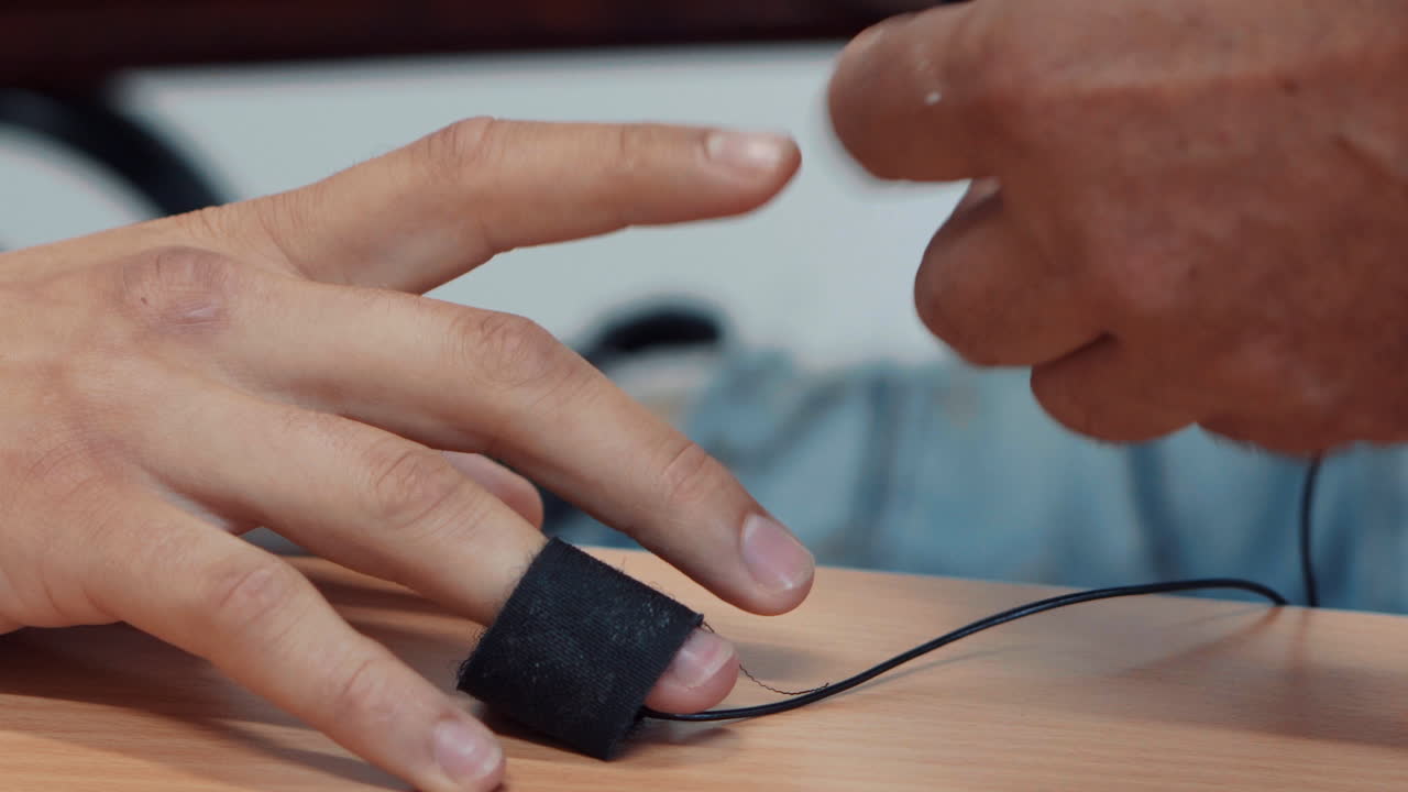 Placing polygraph sensors on a person's fingers