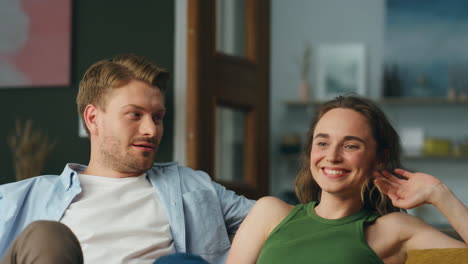 closeup laughing couple resting sofa home. cheerful carefree spouses having fun