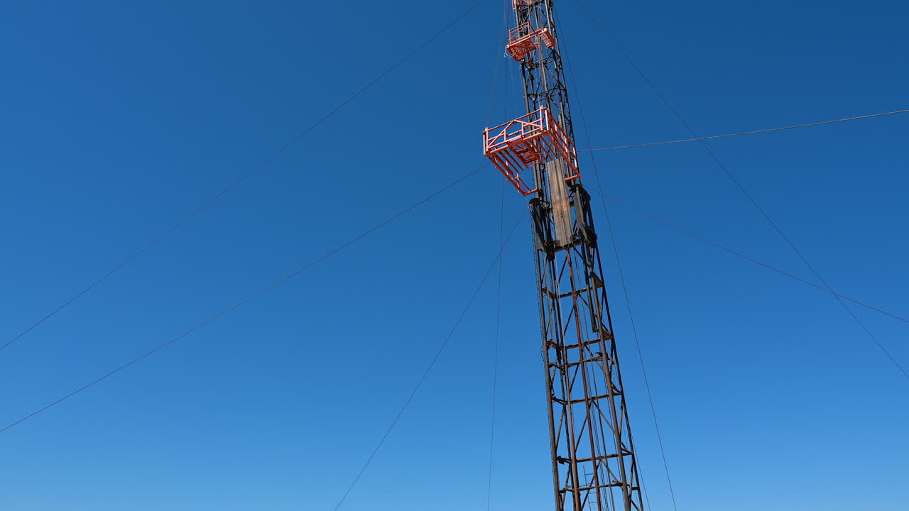 A remote site in desert for the drilling industry. Cars, wagons and metal supports used in the production of oil and gas.