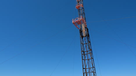 a remote site in desert for the drilling industry. cars, wagons and metal supports used in the production of oil and gas.