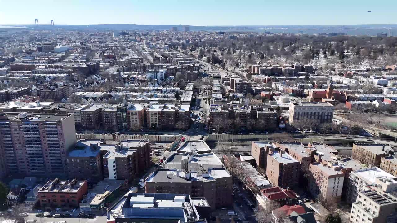 Horizontal drone circling shot over Ocean Parkway in Brooklyn, capturing New York’s urban charm, residential buildings, and dynamic streets with smooth aerial rotation.