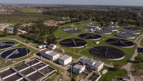 aerial shot of large modern water purification plant with tanks during sunlight in buenos aires,argentina