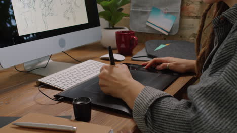 graphic designer working on drawing table
