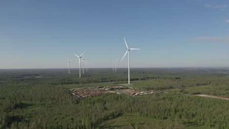 large wind turbines with blades in field aerial view bright morning sky