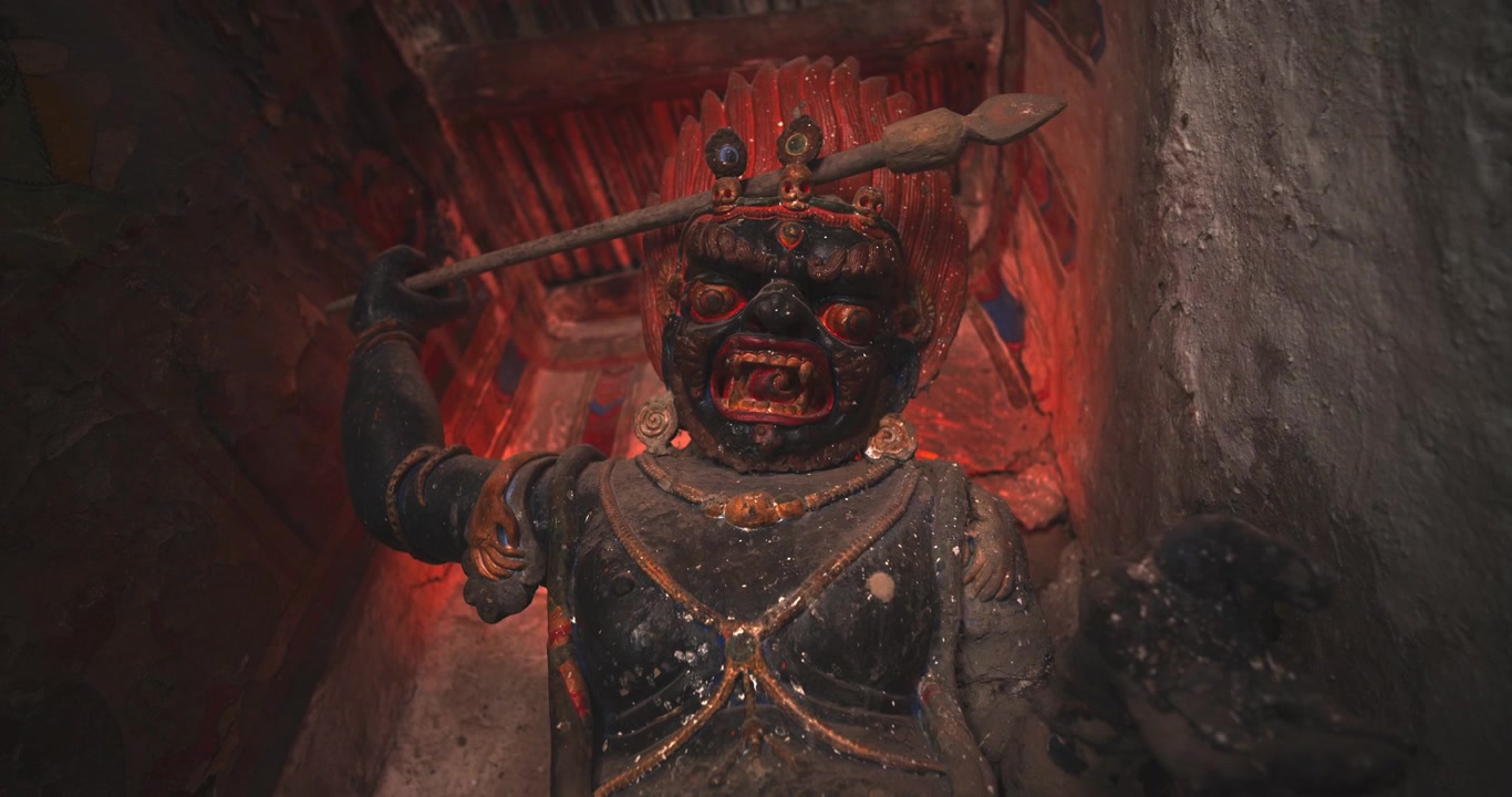 Annapurna Circuit, Manang, Nepal, zoom-out shot revealing the talll ancient clay and pigment Vajrapani protector statue in Bhraka Monastery