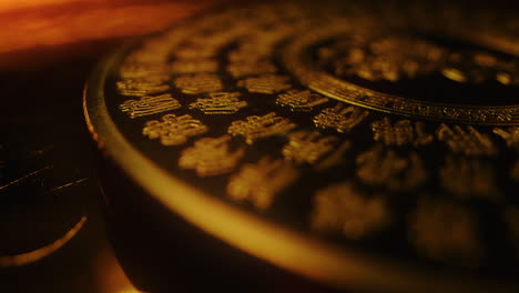 golden sacred plate with gold ideogram chinese alphabet printed rotate slowly close up