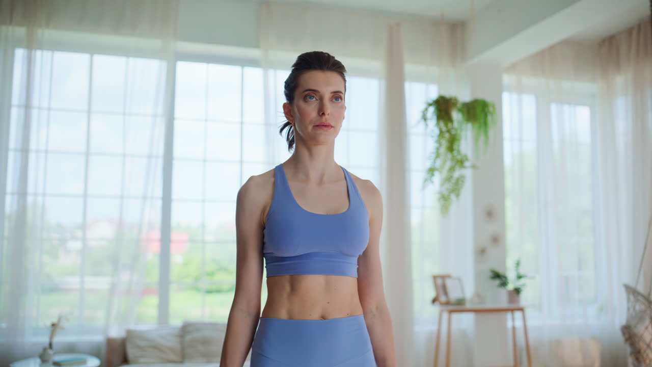 Woman flexing muscles dumbbells standing living room closeup. Strong sportswoman