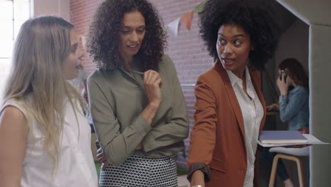 multi ethnic business women brainstorming ideas for research project using graph data on laptop pregnant boss woman sharing strategy in modern office workplace