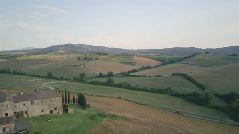 aerial view of characteristic tuscany landscape with cypress hill switchback road in calm quiet countryside of italy