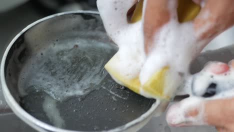 hand washing a cooking pan ,