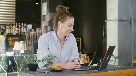 woman working on laptop in a cafe