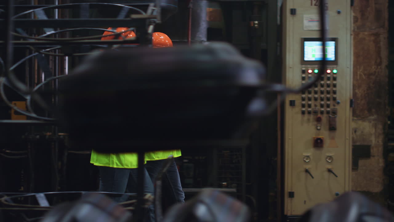 Professional attractive partners walking at huge modern technologies factory.