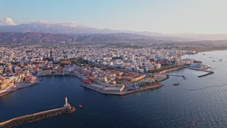 aerial view of chania, crete showcasing waterfront and cityscape at sunset